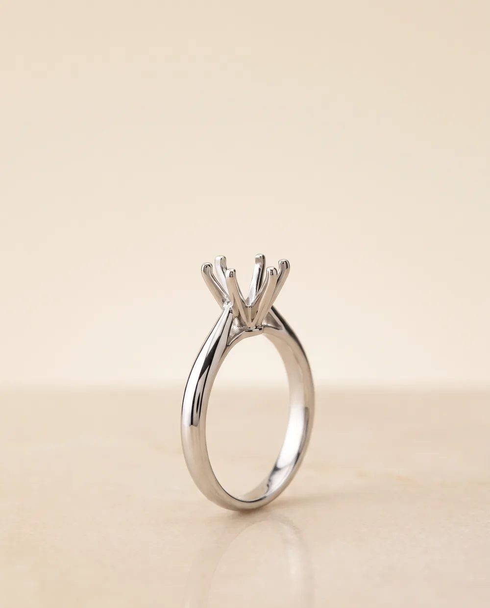 A platinum engagement ring setting with an empty six-prong head