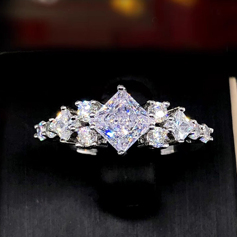 1+2 Vertical Princess Cut Main Stone & 8 Round Cut Accents Man Made Diamond Ring black background image