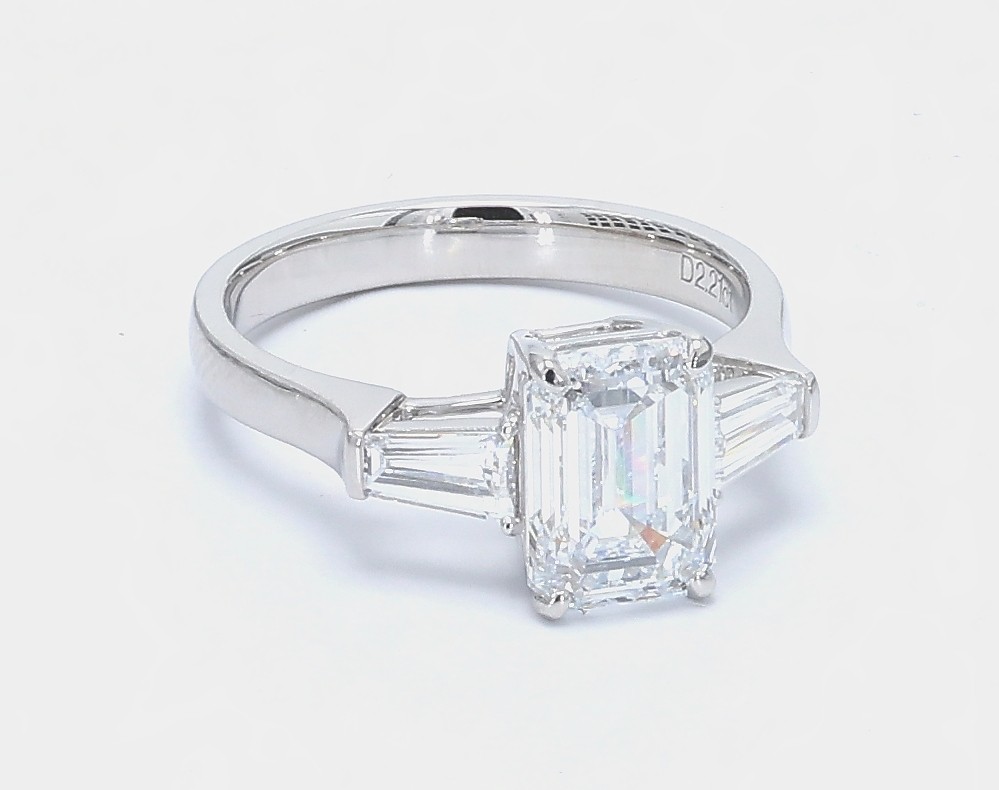 2.21 ct. Eternity Center Emerald Stone With 2 Trapezoid Side Stone Engagement Ring in polished white gold