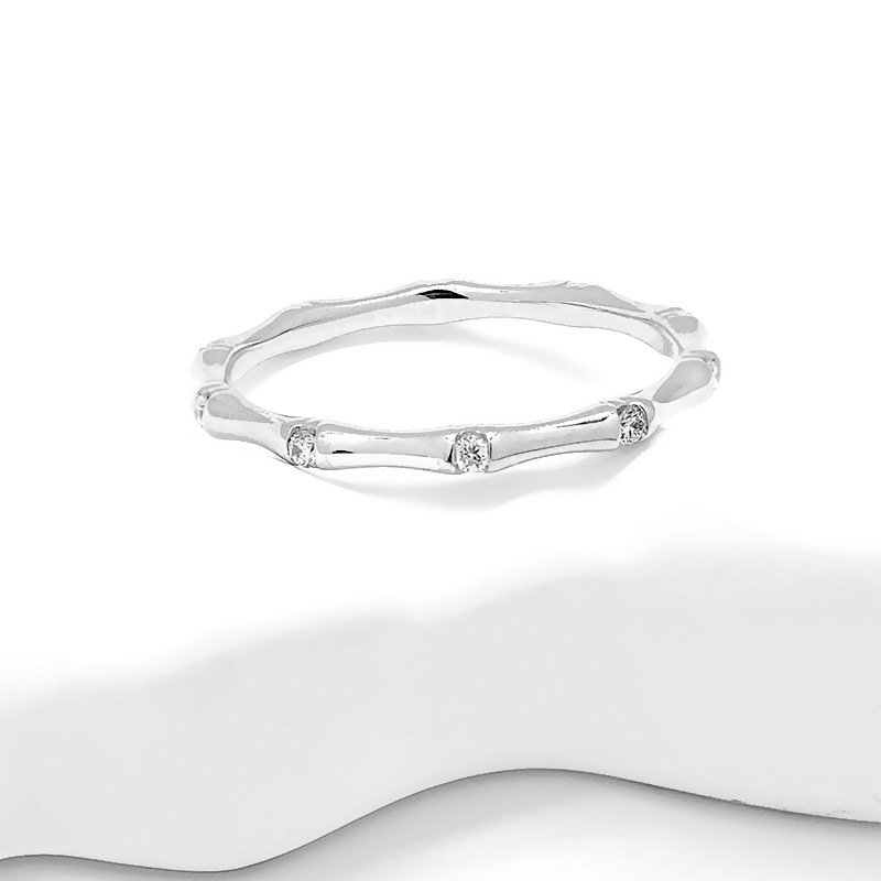 Bamboo Motif Bezel White Gold Synthetic Diamond Slim Stackable Fashion Band on table