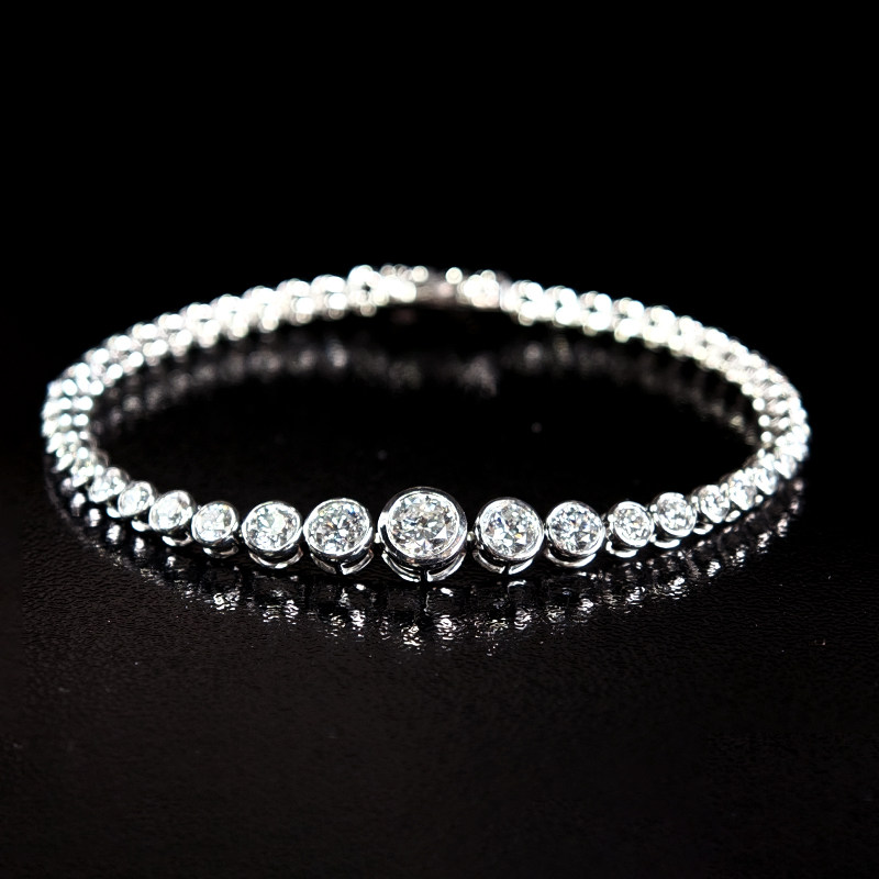 Continuous Bubble Bezel Set Dual Layer Open Gallery Diamond Tennis Bracelet on table