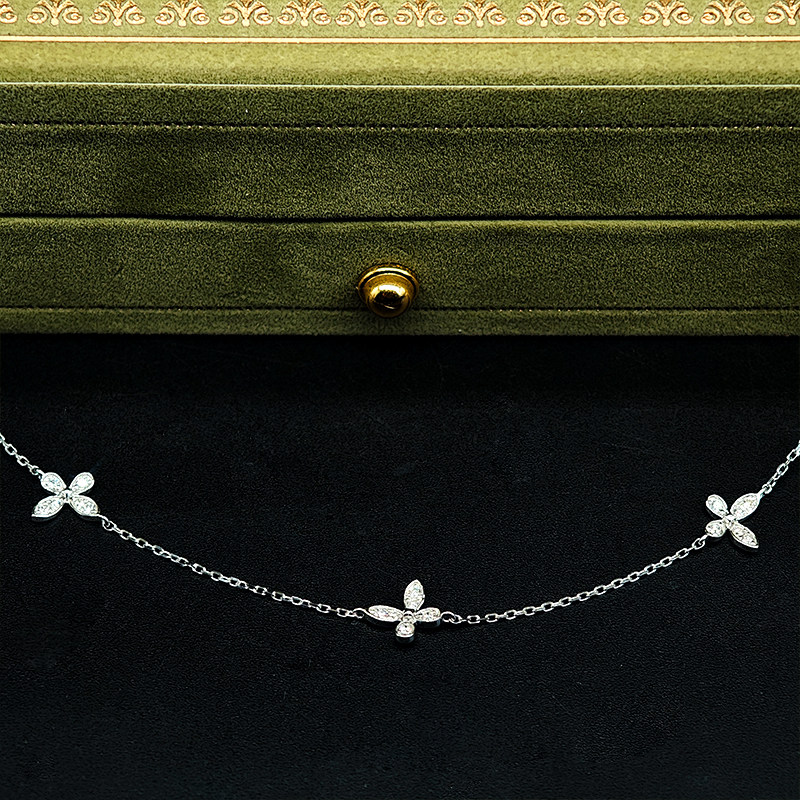 Alternating Petite Butterfly Motif Pave Cultivated Diamond Necklace in front of green box