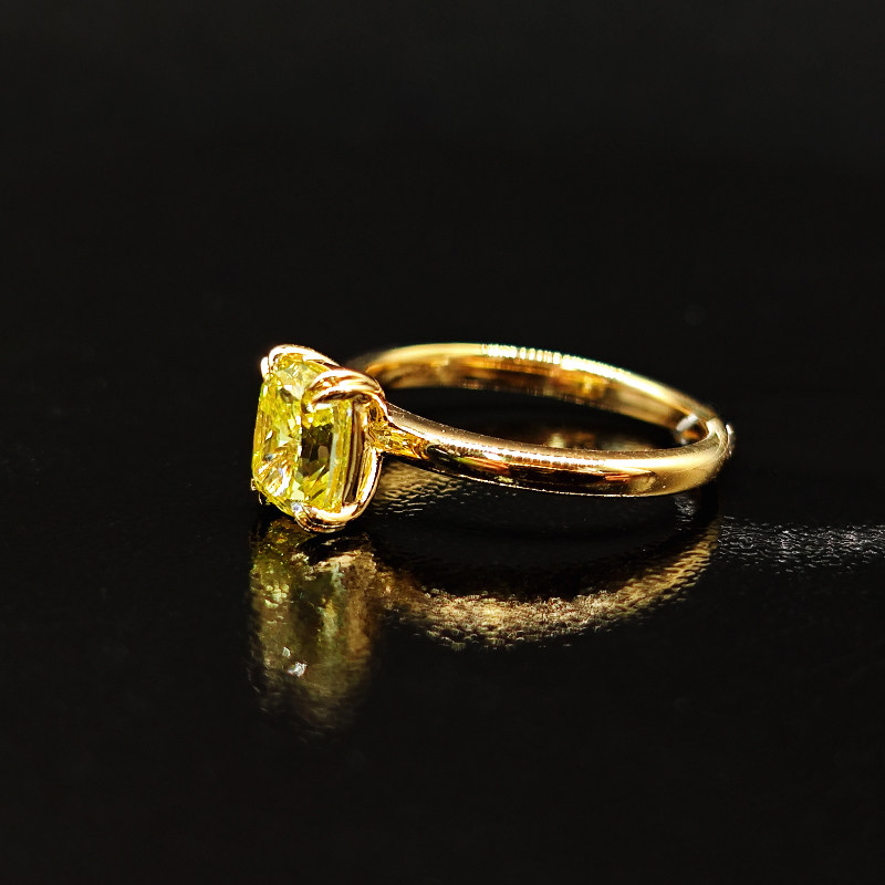 Cushion Cut Four Prong Yellow Lab Diamond Engagement Ring With Plain Round Band on desk