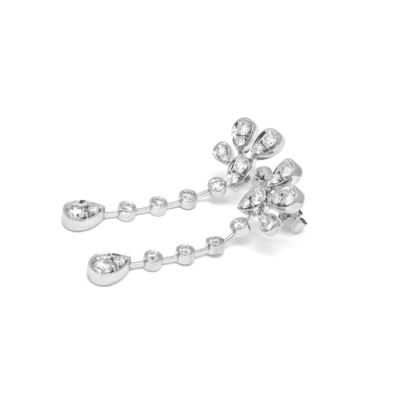 Teardrop Pave Floral Top Linear Chain Lab Grown Diamond White Gold Drop Earrings lay on table