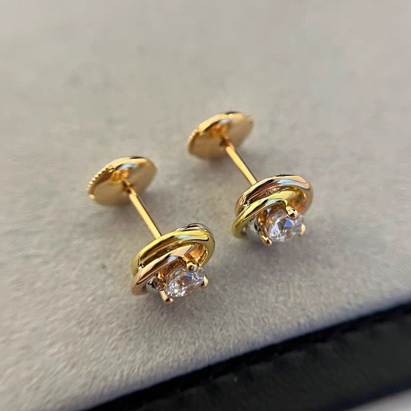Rose Motif Solitaire Round Cut Diamond Rose Gold Stud Earring on table