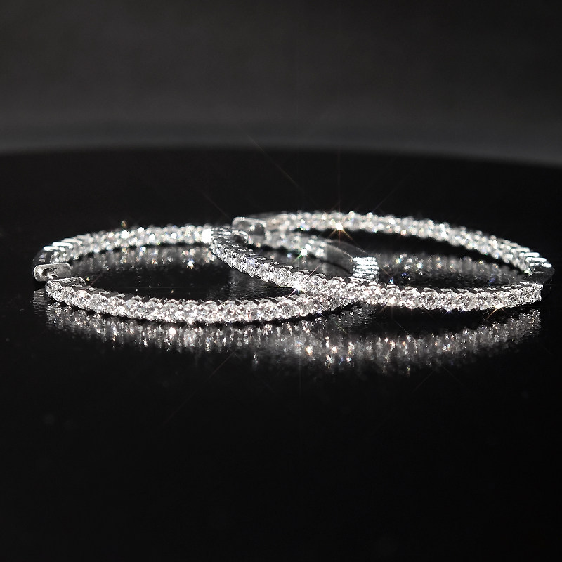 Full Eternity Dual Layer Open Gallery Lab Diamond Slim White Gold Hoop Earrings lay on table
