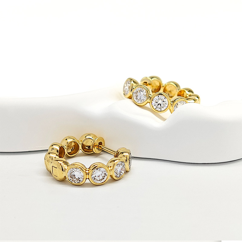 a pair of Yellow Gold Bezel Set Lab Diamond Hoop Earrings
