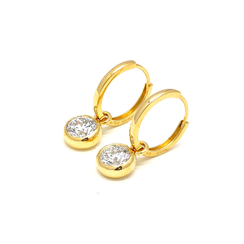 Yellow Gold Bubble Bezel Set Solitaire Round Cut Diamond Drop Earrings lay on table