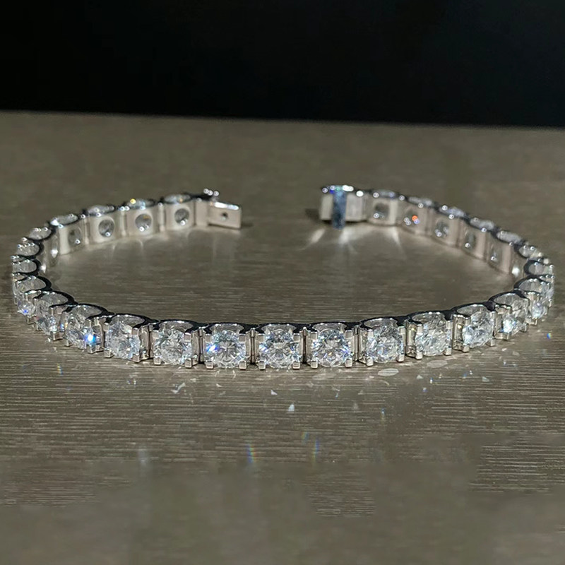 Classic Bull Head Set Round Cut Lab Cultured Diamond Tennis Bracelet lay on table
