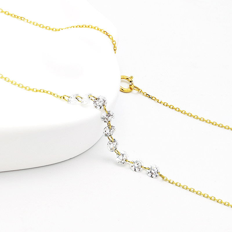 9 Pierced Lab Diamonds Alternating Connected Yellow Gold Necklace lay on table
