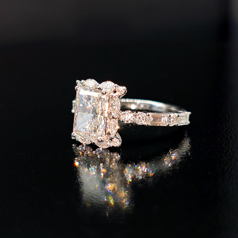 Sparkling Radiant Cut Marquise Side Accents Diamond Ring With Round & Emerald Accents On Shoulder side view