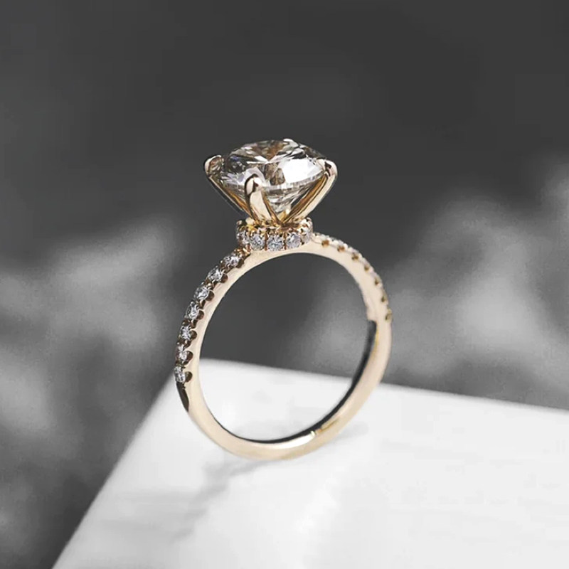 Four-prong diamond ring with half-circle setting
