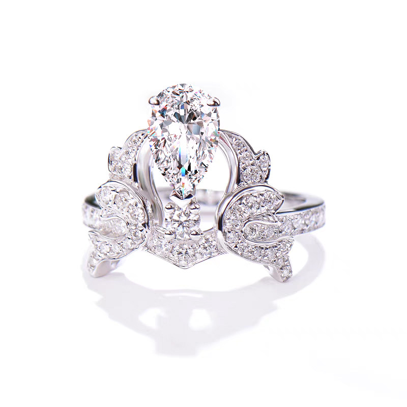 Crown Inspired Pear Cut Main Stone Diamond Ring With Half Pave Shank in blank background Image