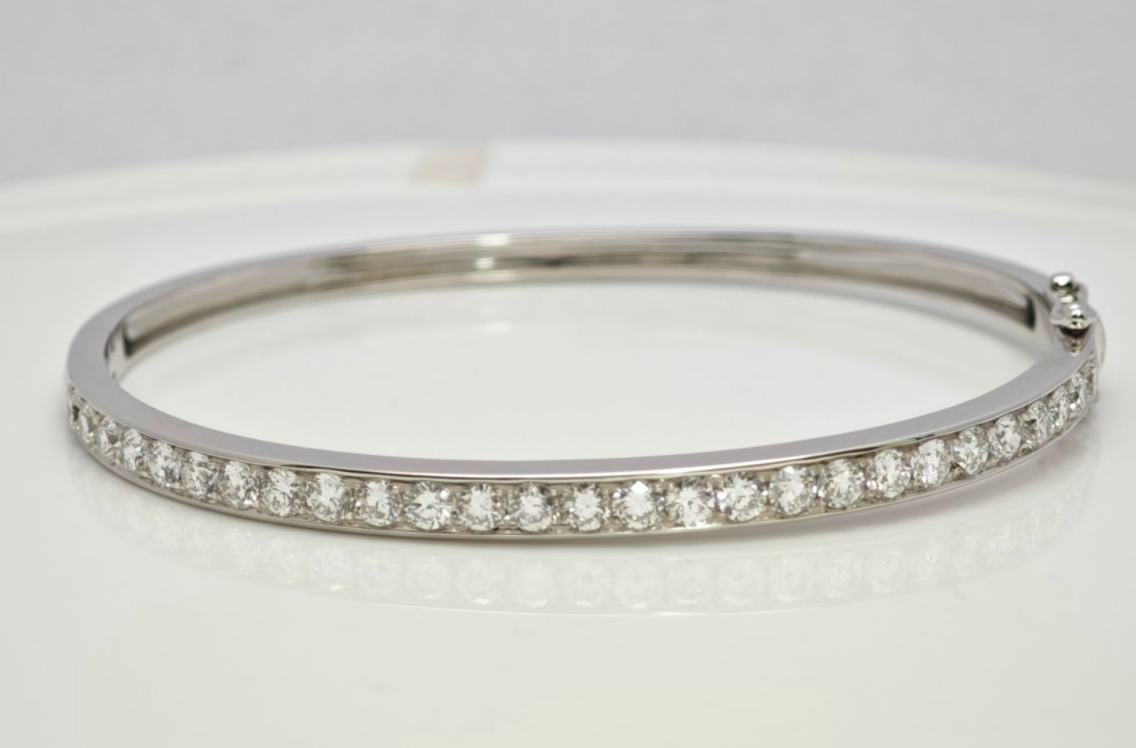 Half Row Channel Set Round Synthetic Diamond Sleek Classic Tennis Bangle Bracelet lay on table