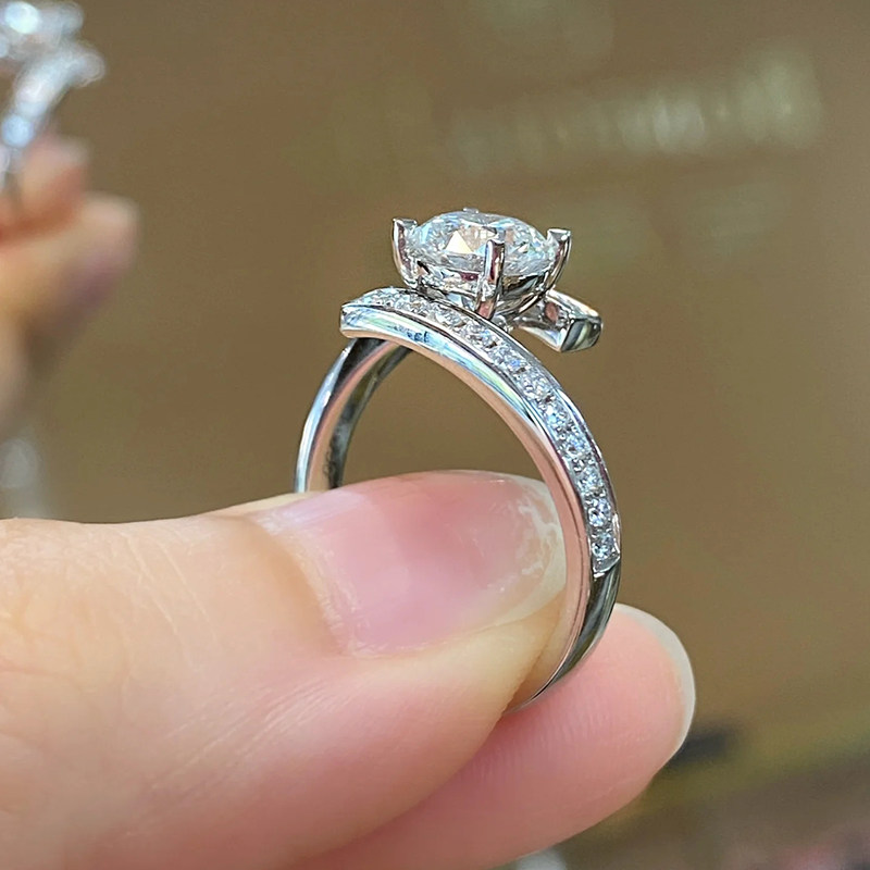 4 Prong Solitaire Round Lab Diamond Ring With Symmetric Bypass Half Pave Shank in hand
