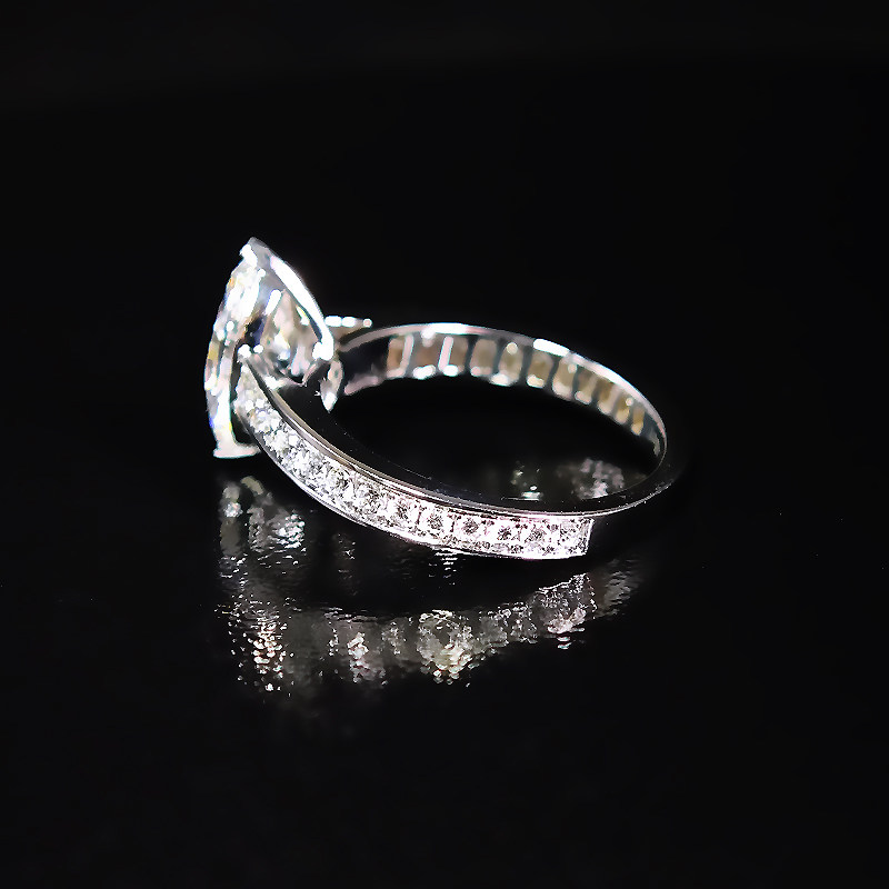 Marquise Cut Solitaire 2 Prong Vertical Setting Diamond Ring With Half Channel Pave Shank lay on desk
