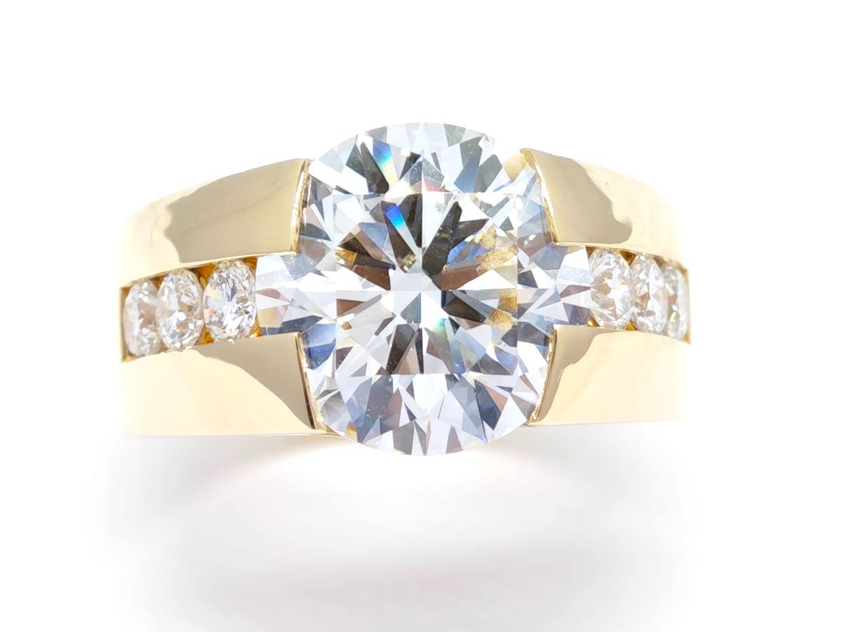Oval Cut Wide Bezel Synthetic Diamond Bold Channel Side Stone Solitaire Ring