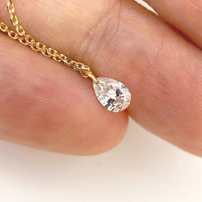 Floating Solitaire Pear Cut Lab Cultured Diamond Necklace in hand