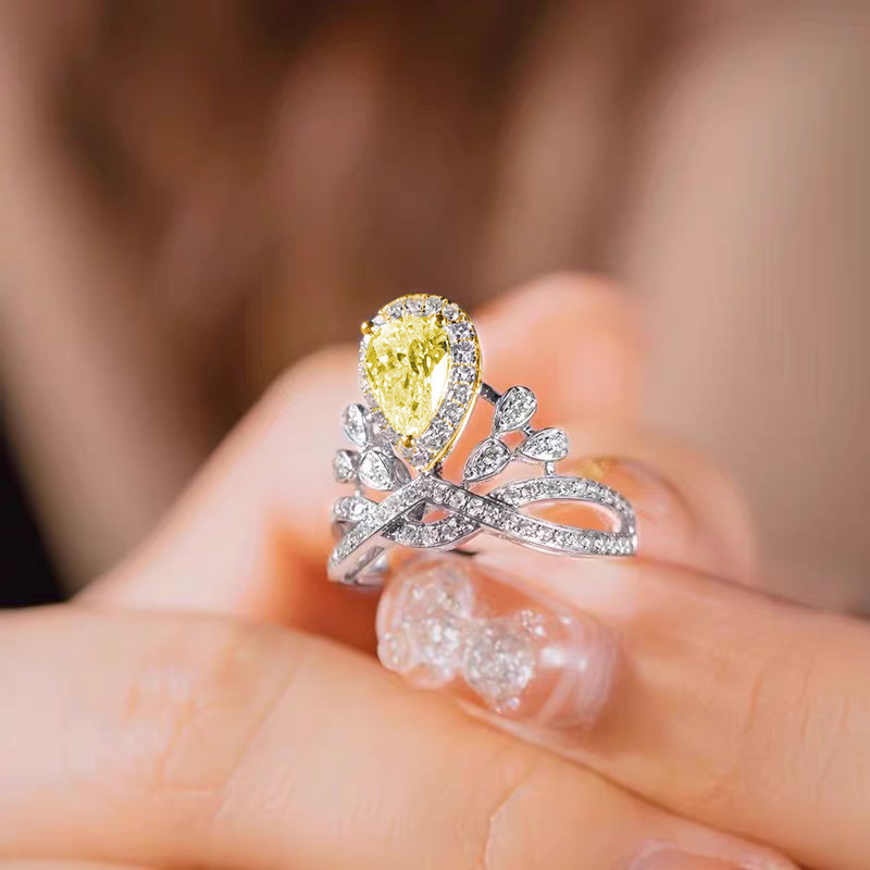 Crown Inspired Yellow Pear Cut Halo & Accents With Crisscross Staggered Overlapping Band in hand