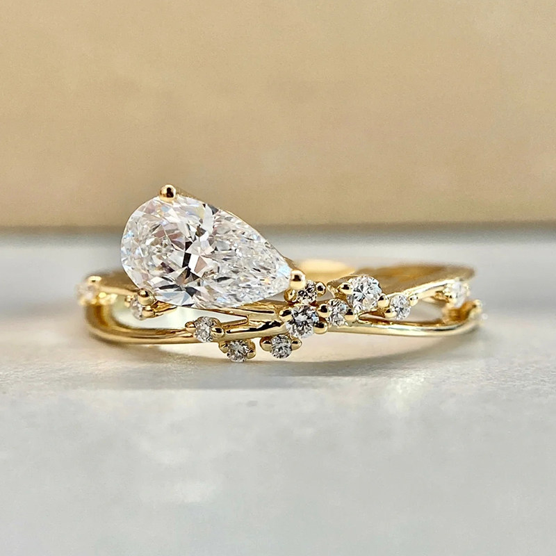 Vine Motif Pear Cut Main Stone Accents Ring With Crisscross Band