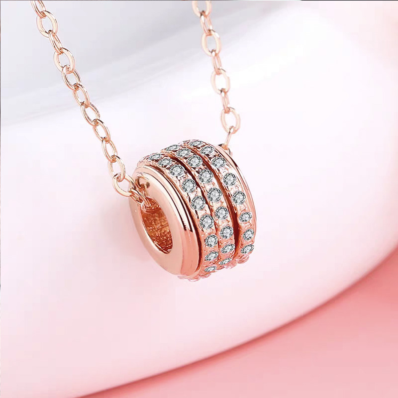 Rotatable Screw & Nut Barrel Full Pave Lab Diamond Pendant Rose Gold Necklace in hand
