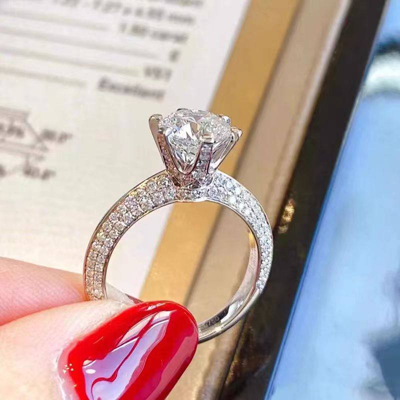 6 Prong Round Stone Hidden Halo Diamond Ring With 4 Row Half Pave Shank in hand