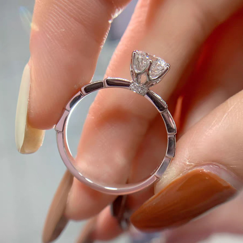 6 Prong Open Gallery Diamond Ring With Trapezoid Overlapping Pave Shoulders in hand