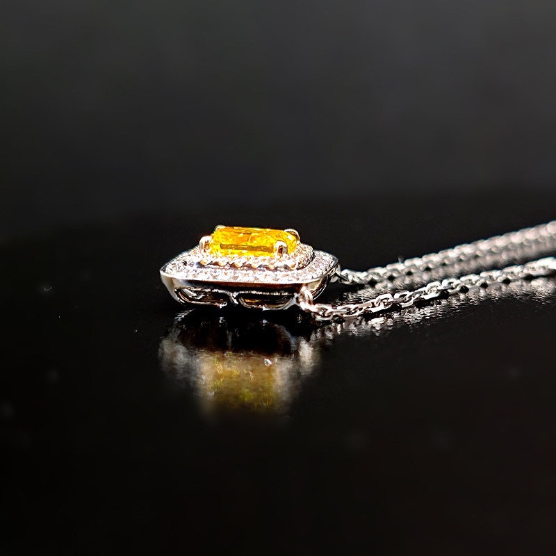 Sugar Cube Motif Yellow Radiant Cut Solitaire Double Halo Diamond Necklace lay on desk