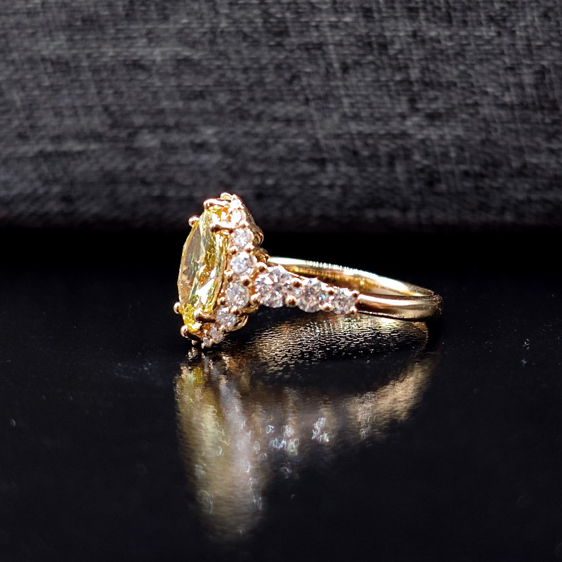 Yellow Marquise Cut Cluster Halo Lab Diamond Ring With Accents Shoulder Band on table